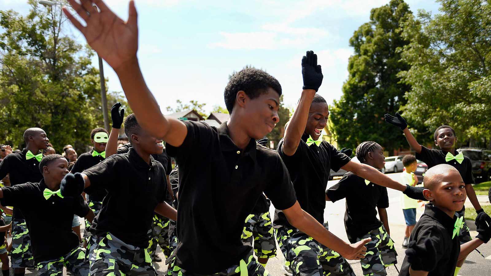 Young men from the Like Brothers dance team march in the 2015 Juneteenth celebration parade.