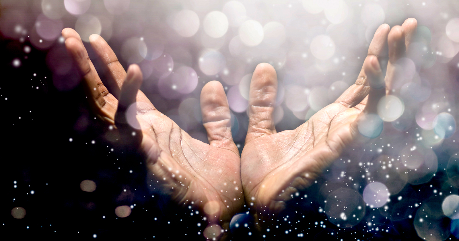  Picture of two hands reaching towards starlight falling.