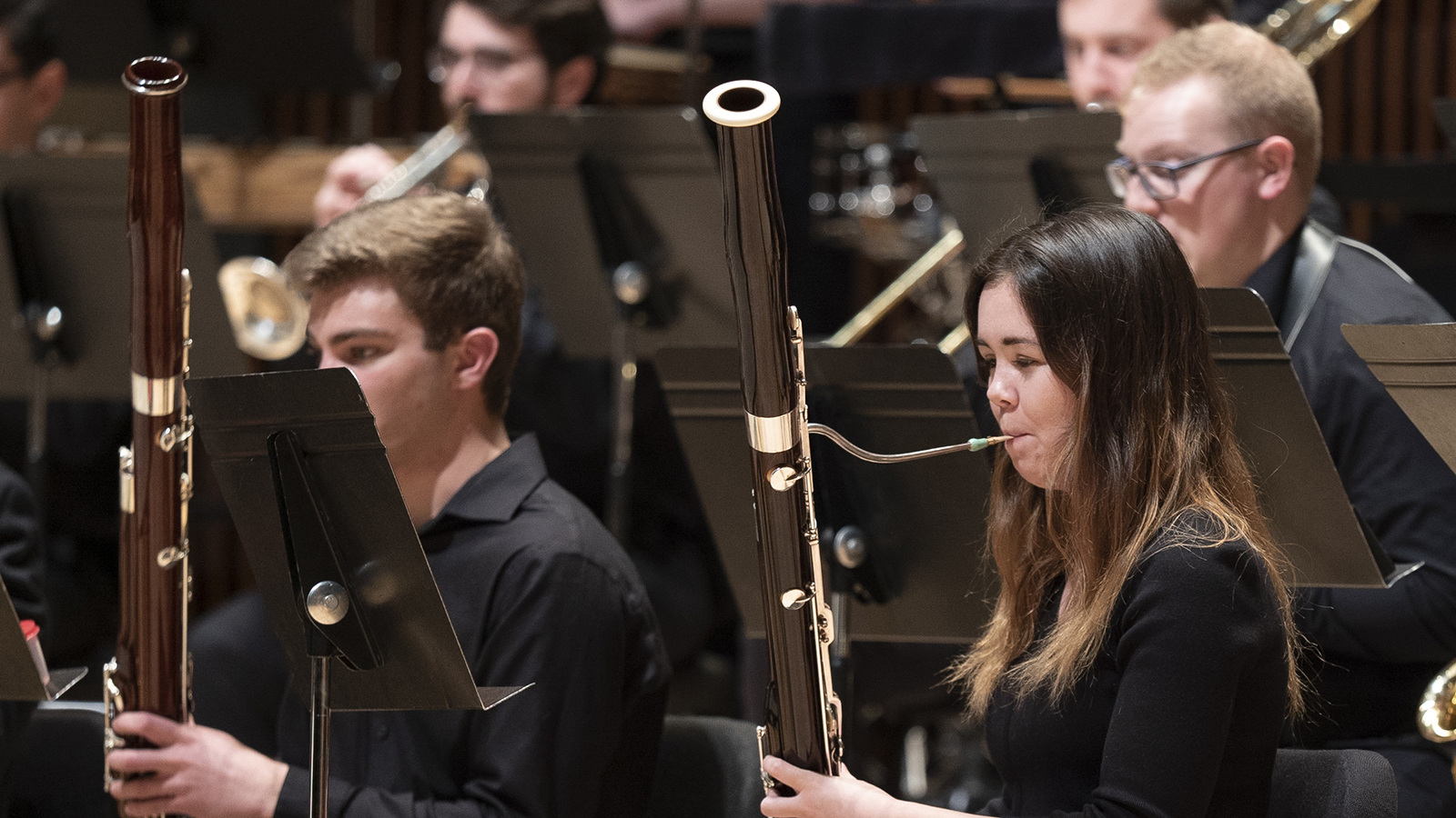 Close-up shot of two bassoonists performing in an UMWO concert.