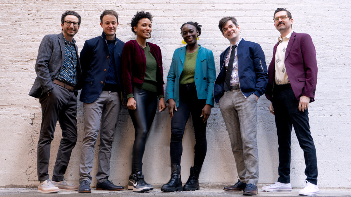 Six band members pose for picture.