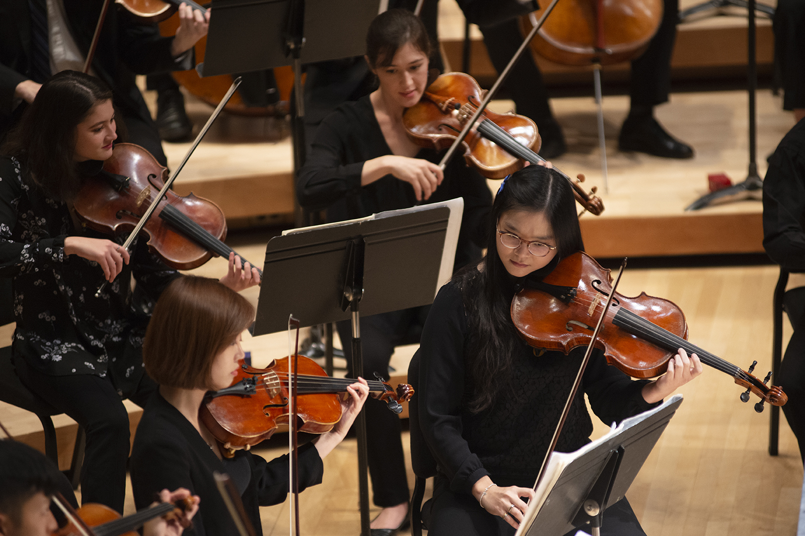An orchestra performs on stage.