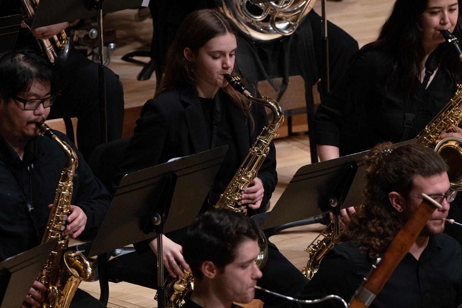 University Wind Orchestra members perform on stage.