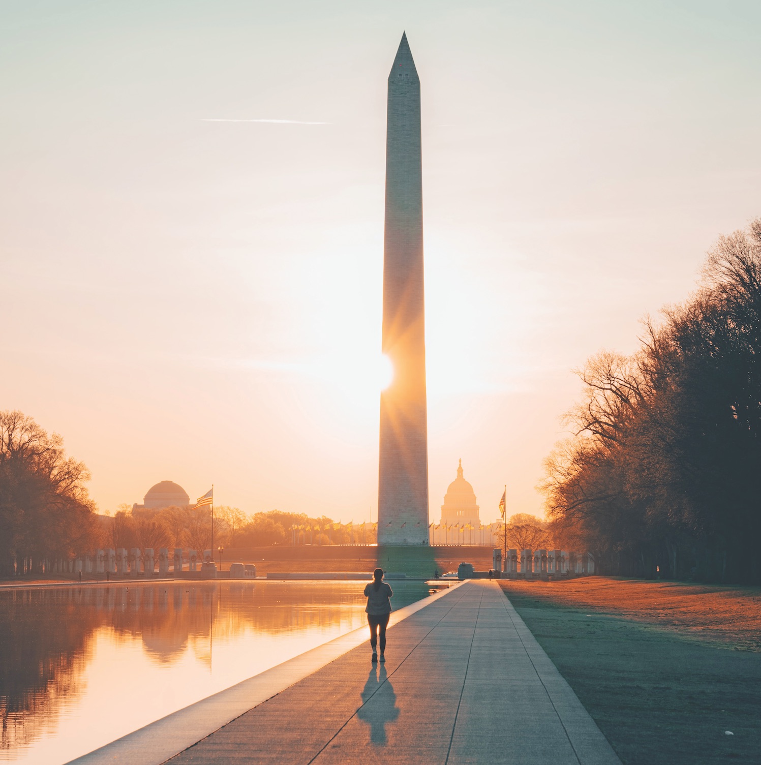 A woman jogs towards the Washington Monument in Washington D.C.