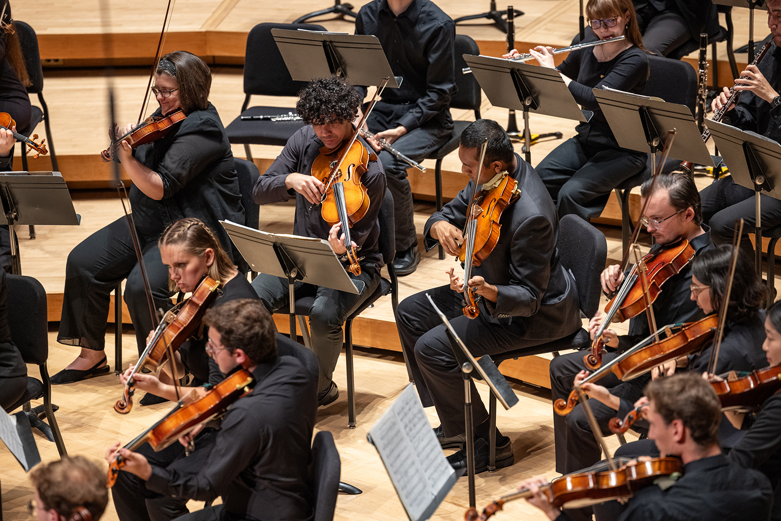 Members of the UMD Symphony Orchestra perform on stage.