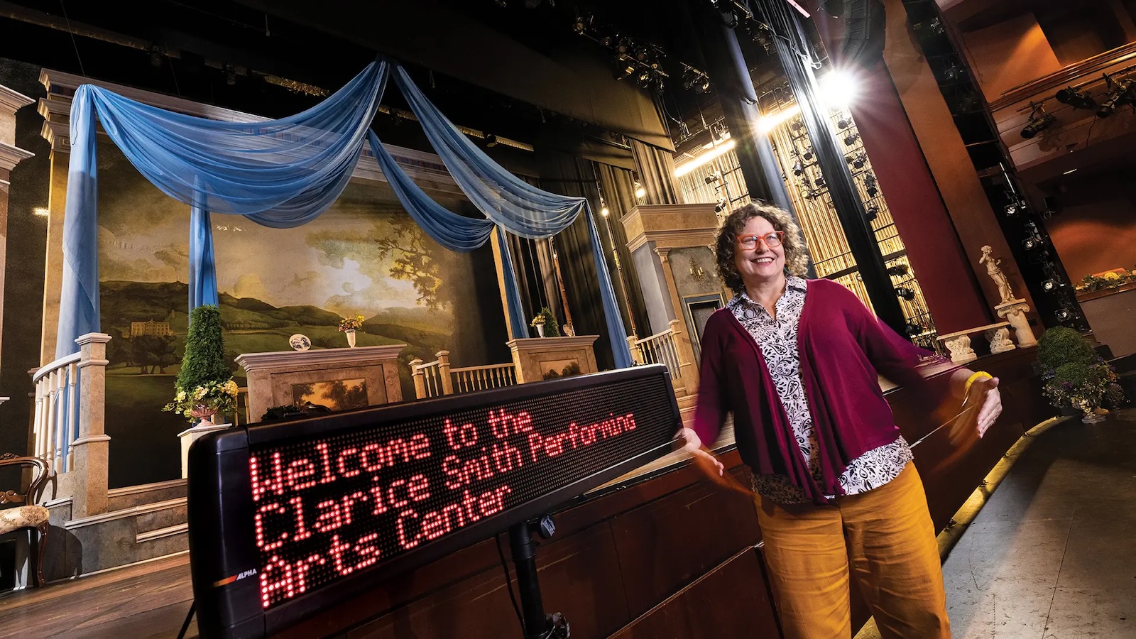 Jill Bradbury in front of the Kay Theatre stage at The Clarice