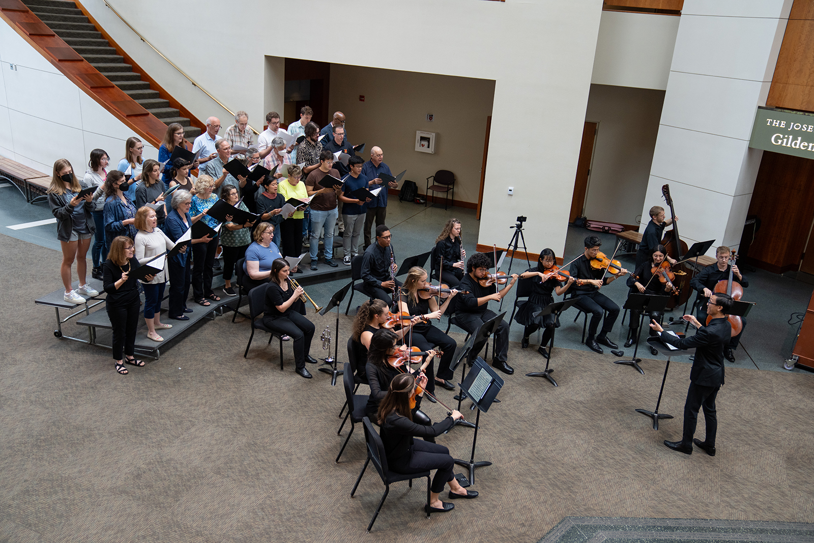 Choral members sing in the lobby of the Clarice.