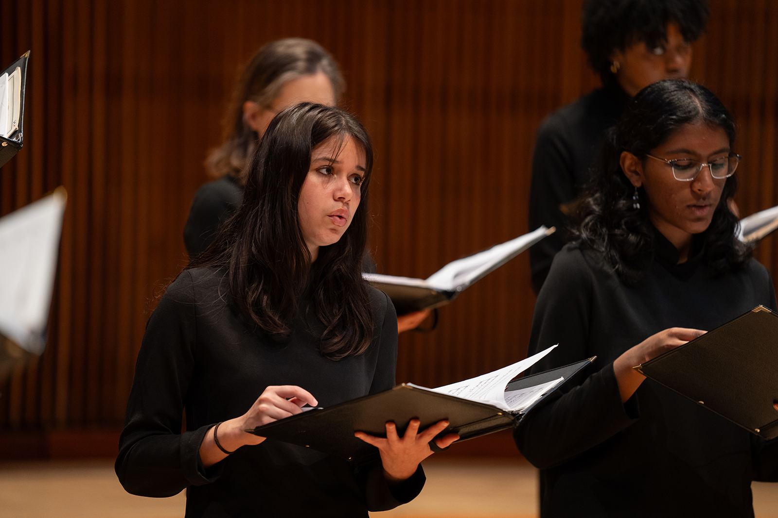 UMD choral students sing on stage.