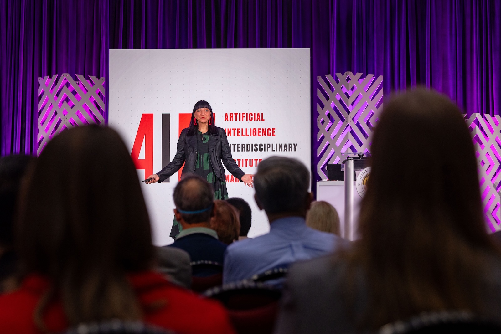 Neda Atanasoski stands in front of a screen talking to a group of people.