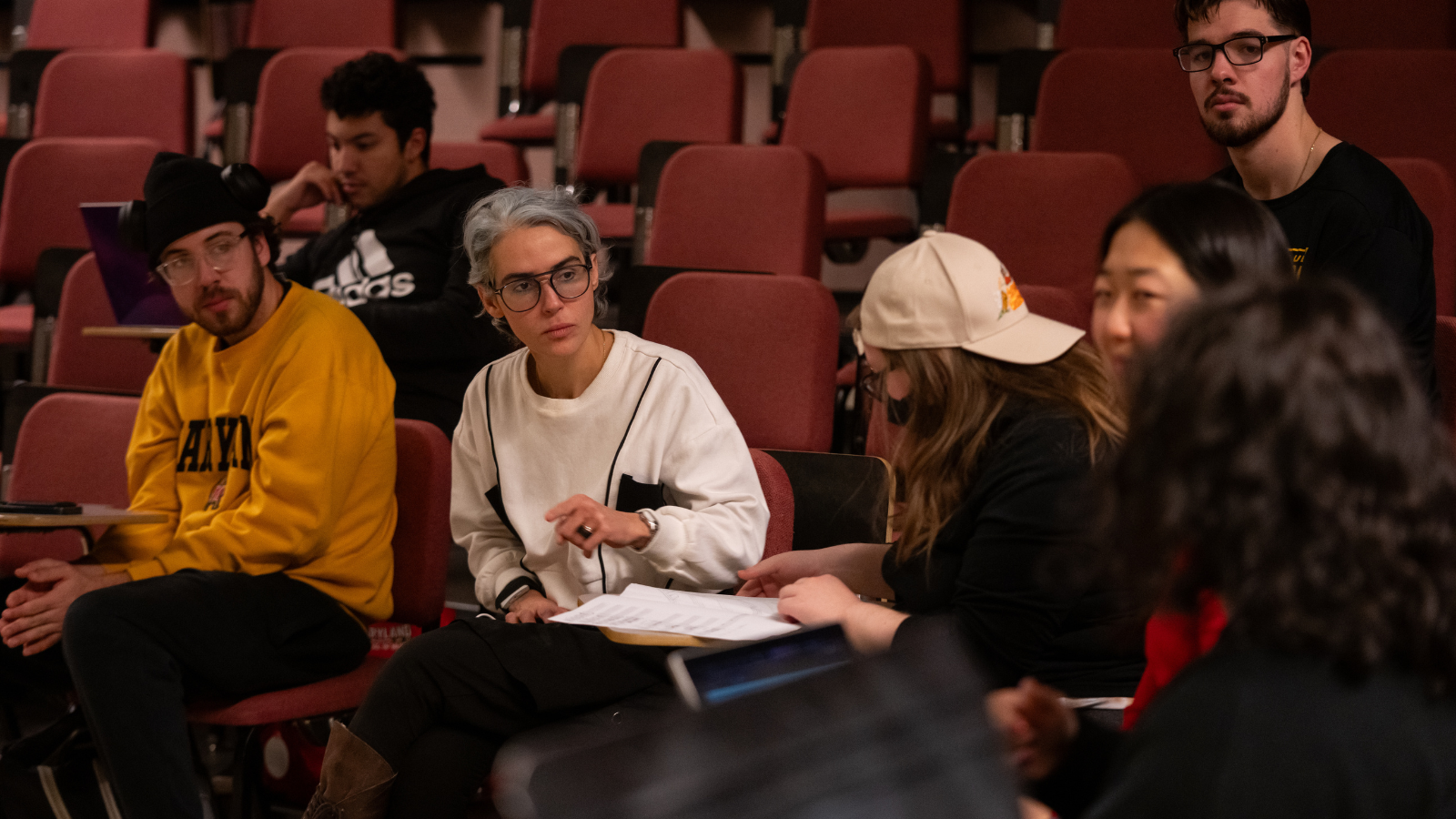 Clarice Assad works with students in a theatre.