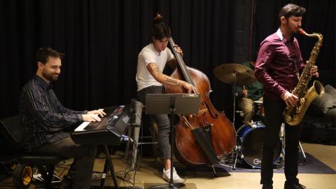 Three men play jazz instruments at The Hall, a restaurant in College Park, Maryland..