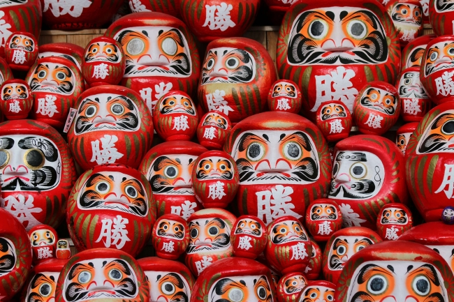 unsplash image of japanese daruma red dolls