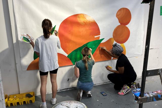 students working on a mural
