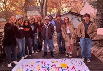 Members of Requiem Zine pose for a photo outside.